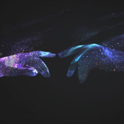 Hands in a digital universe background